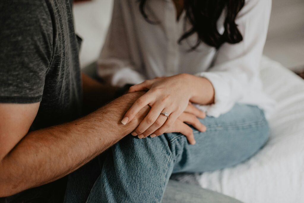 A tender moment of a couple holding hands, symbolizing love and connection.